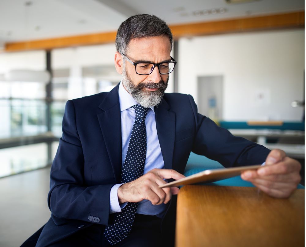 Businessmen looking at his tablet smiling